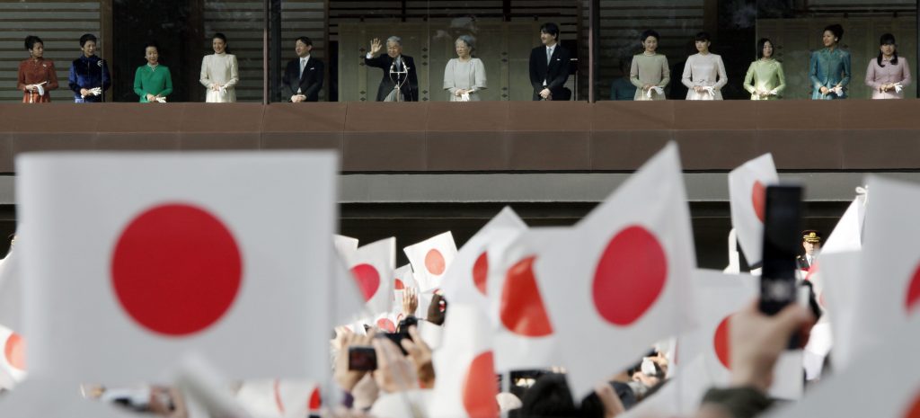Japan's Emperor Akihito, center, with his family members, wavees to well-wishers from the palace balcony during a New Year's public appearance at the Imperial Palace in Tokyo, Monday, Jan. 2, 2012. (AP Photo/Koji Sasahara)